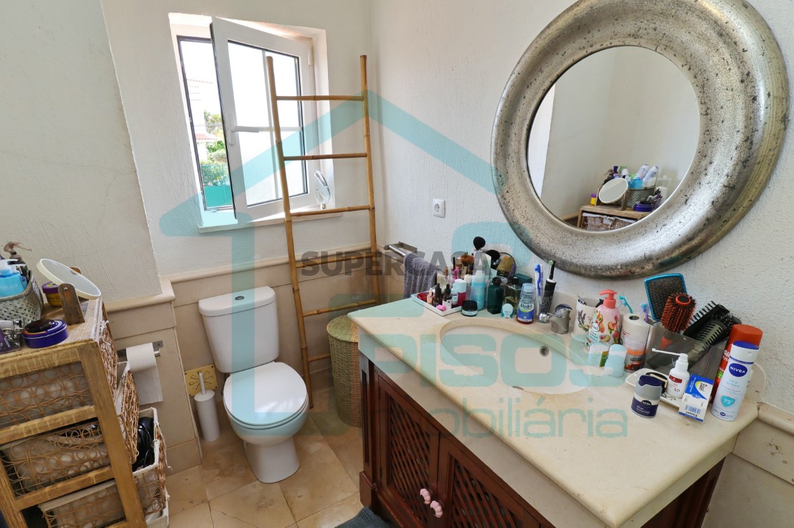 Bathroom with bathtub, window, furniture with worktop