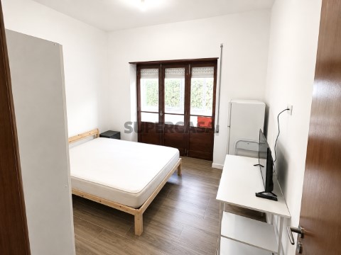 Minimalist Bedroom with French Doors and TV